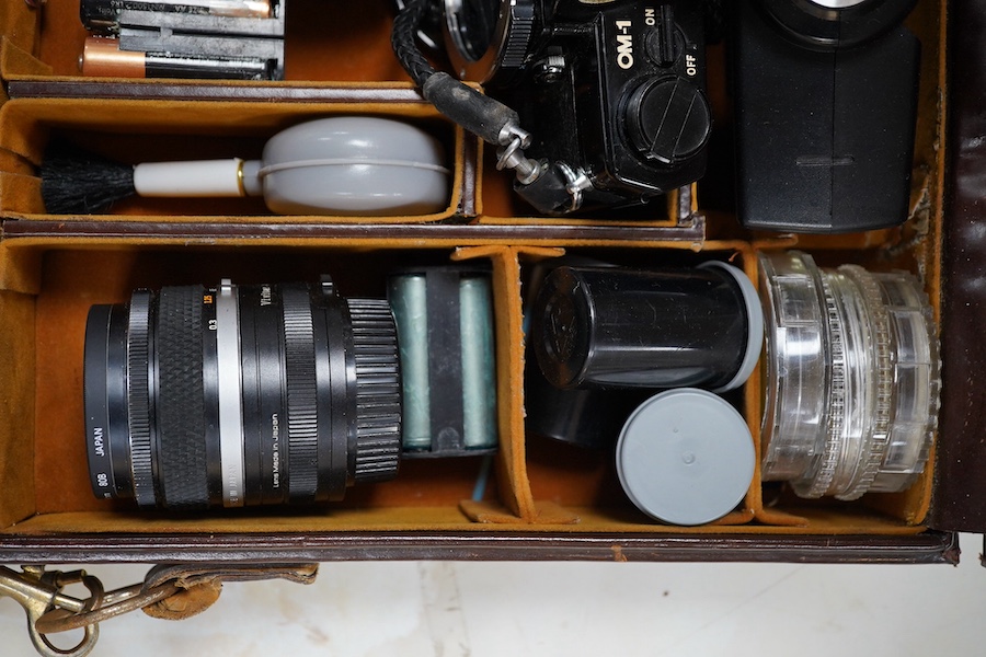 A cased Olympus camera, lenses and equipment, Condition - poor